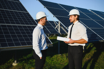 Project manager discuss with worker installation process of solar panel