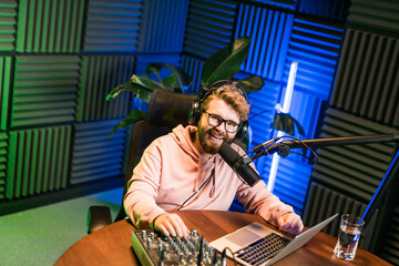 Handsome man radio DJ hosting a radio show, entertainment and communication concept