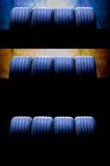 Car tires with tread for Summer. Summer tires in dark warehouse, in three lighting variants. Warm and Cold colors like seasons and weather and road conditions. Road safety - car wheels