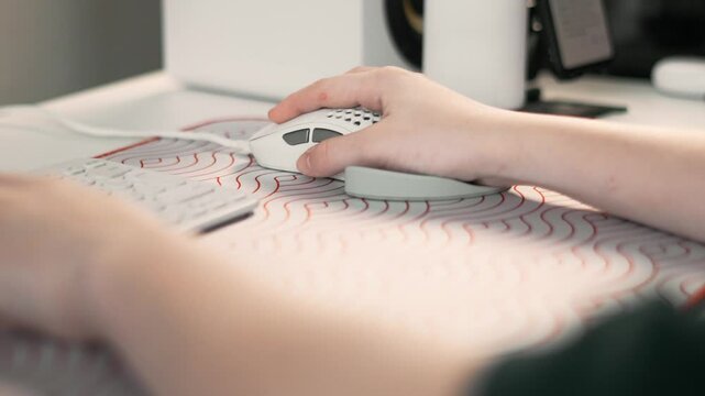 Well-organized gaming desk with hands on peripherals designed for productivity and style. Combination of sleek equipment and thoughtful layout elevates gaming sessions and inspires creativity.