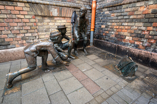 Budapest, Hungary, August 29, 2022. Street view with the representation with metal statues of a moment of play of the boys of Pal street, a famous book for young people.