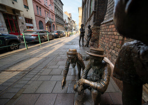 Budapest, Hungary, August 29, 2022. Street view with the representation with metal statues of a moment of play of the boys of Pal street, a famous book for young people.