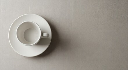 White ceramic coffee cup on saucer against textured beige background, conveying minimalistic elegance, perfect for cozy beverage settings and modern dining experiences