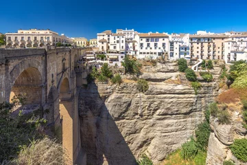 Foto auf Acrylglas Ronda Puente Nuevo The Puente Nuevo bridge in El Tajo gorge in Ronda town in Spain. Ancient stone bridge spanning a deep gorge, overlooking a picturesque town of white buildings.  © Viliam