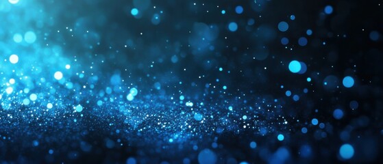 Abstract blue glitter sparkle bokeh background with glowing light effect for festive celebration and magical winter holiday season