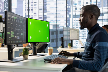 Developer conducting experiments and tests on green screen computer to optimize machine learning...