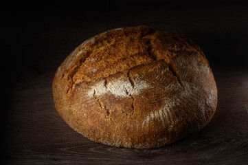 Freshly baked rustic bread resting on a wooden surface, capturing the essence of artisanal baking...