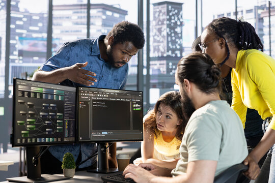 Team of developers doing brainstorming to create machine learning models that can process and analyze data to improve decision making processes. IT staff members working together in office