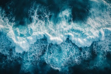 Fototapeta premium A view from above of the dynamic and ever-changing appearance of rough waves breaking due to a typhoon or strong wind.