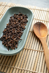 dried clove grains in bowl in close-up	