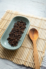 dried clove grains in bowl in close-up	