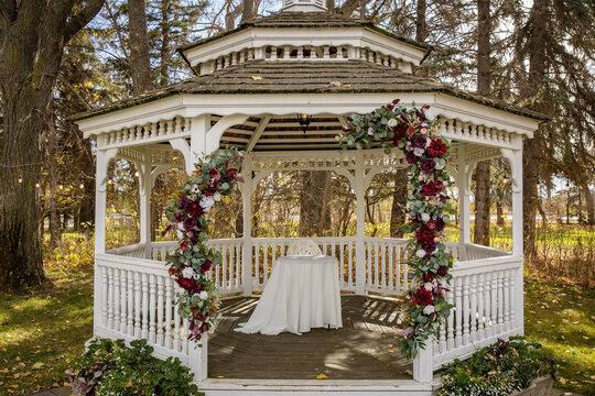 Beautiful white gazebo and floral wedding archway with gorgeous fall colours