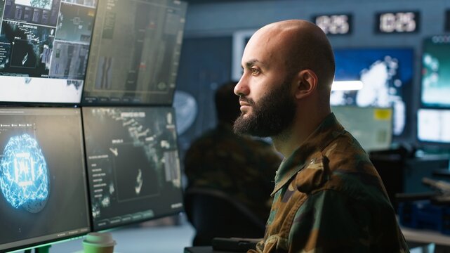 Army computer scientist employing AI technology in military planning and decision making processes. Expert uses artificial intelligence to enhance armed forces operational capabilities, camera A