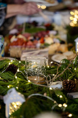 Charcuterie spread with Christmas decorations and lights