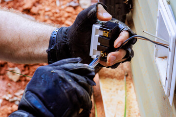 Process of connecting electrical wires to new outlet, crucial step in home wiring meticulous work involved in electrical installation