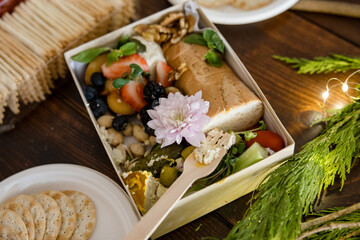 Charcuterie spread with Christmas decorations and lights