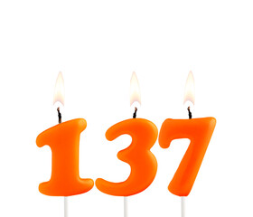 Orange birthday candle on white background - Number 137
