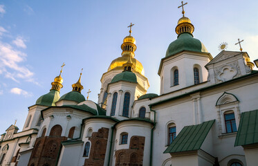 Historic Orthodox St Sophia Cathedral with golden domes and white walls, set against striking clear blue sky. Kyiv Ukraine. Representation of culture, architecture, and spiritual significance