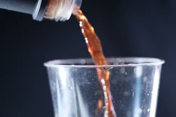Pouring pomegranate vinegar into cup