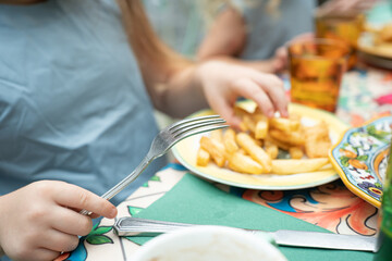 girl eating  fries in a cafe
plate with fries