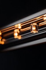 Naklejka premium Close-up of warm-toned lights illuminating a dark background.