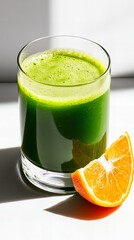 Refreshing green juice with a slice of orange. Perfect for a healthy start to the day!