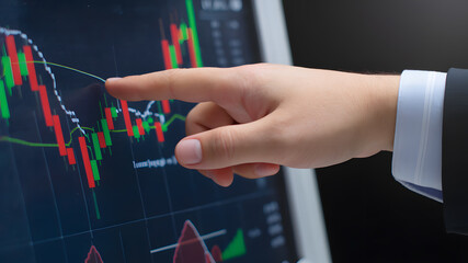 A close-up of hands pointing at stock market candlestick charts, illustrating market trends, price movements, and financial trading analysis.