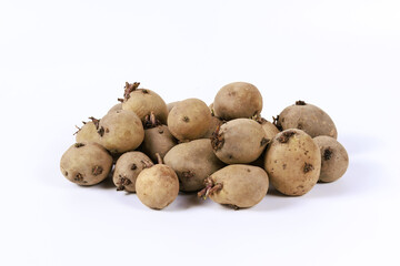 On white background, sprouted potatoes stand out, signaling their potential. Contrast of potatoes...