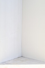 Corner of white wall. Minimalistic empty studio room background for product display. Interior design advertising serene setting
