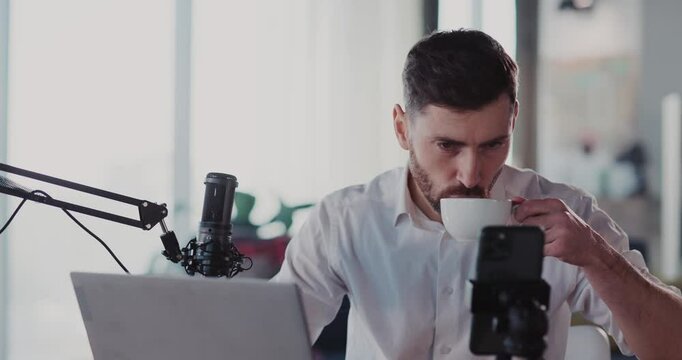 Caucasian attractive adult recording business podcast for online friends audience vlogging lifestyle staying home on quarantine social distance.