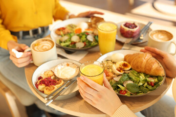 Women having tasty breakfast in cafe, closeup