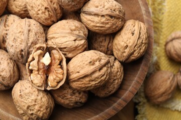 Fresh ripe walnuts in shells on table, top view