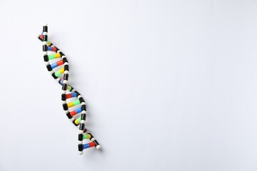 Colorful DNA structure model on white background, top view. Space for text