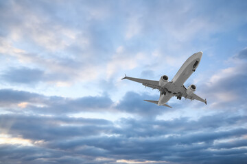 Airplane flying in beautiful blue sky with clouds