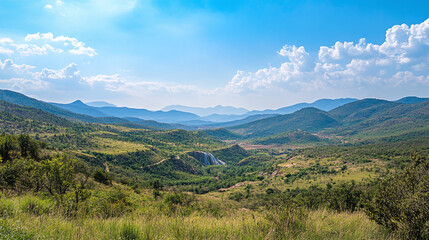 An exotic landscape with lush mountains, sparkling waterfalls, and a blue sky, offering an inspiring, refreshing travel backdrop.