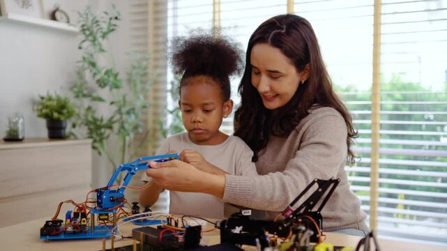 Loving mother and daughter team up for a fun robotics project at home, exploring hands-on STEM activities that inspire creativity, and early engineering skills, fostering problem-solving skills