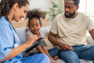 Obraz premium Doctor use tablet for medical checkup consulting african child about health while father sits beside, concept of pediatric healthcare, digital diagnosis, telemedicine, patient care and family support