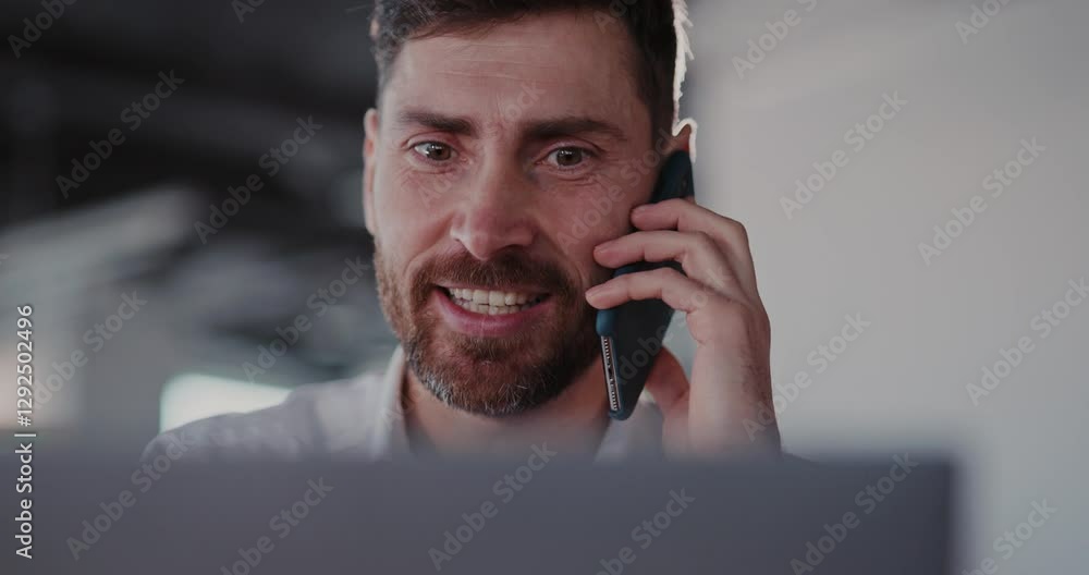 Poster a professional man engaged in conversation on the phone within a modern workspace environment