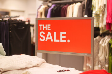 Bright sale sign attracts shoppers in busy retail store