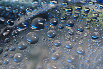 Close-up view of water droplets on a blue surface