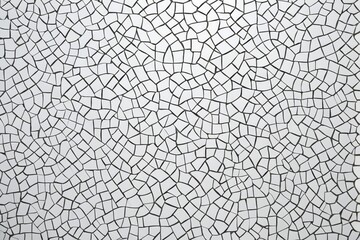a close up of a black and white mosaic tile wall