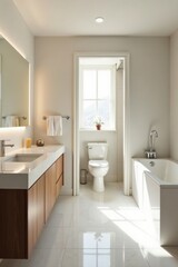 Modern minimalist bathroom with bright sunlight illuminating white tile floor, sleek wooden vanity, and freestanding bathtub
