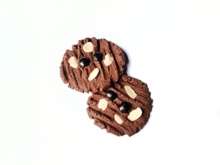 Delicious chocolate cookies with chocochip topping and almond slices isolated on white background.