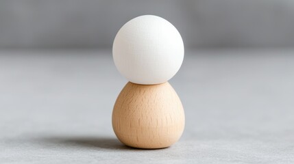 Wooden figurine with white spheres, simple design, neutral background.  Possible use for children's toys, home decor, or design inspiration