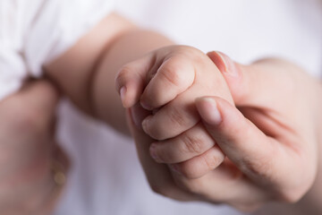 Little newborn baby hands and fingers delicate close up