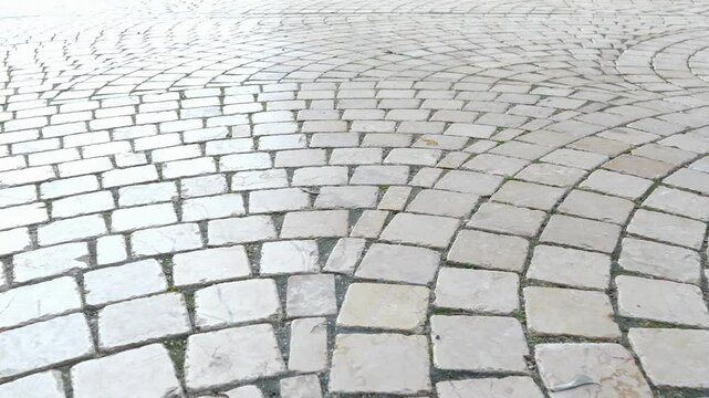 Exploring the unique cobblestone patterns in a lively city square