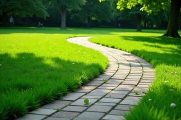 A gently curving stone pathway meanders through a vibrant green lawn, bathed in the warm glow of sunlight, creating a tranquil and inviting outdoor scene.