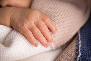 Tiny newborn baby human hands and fingers