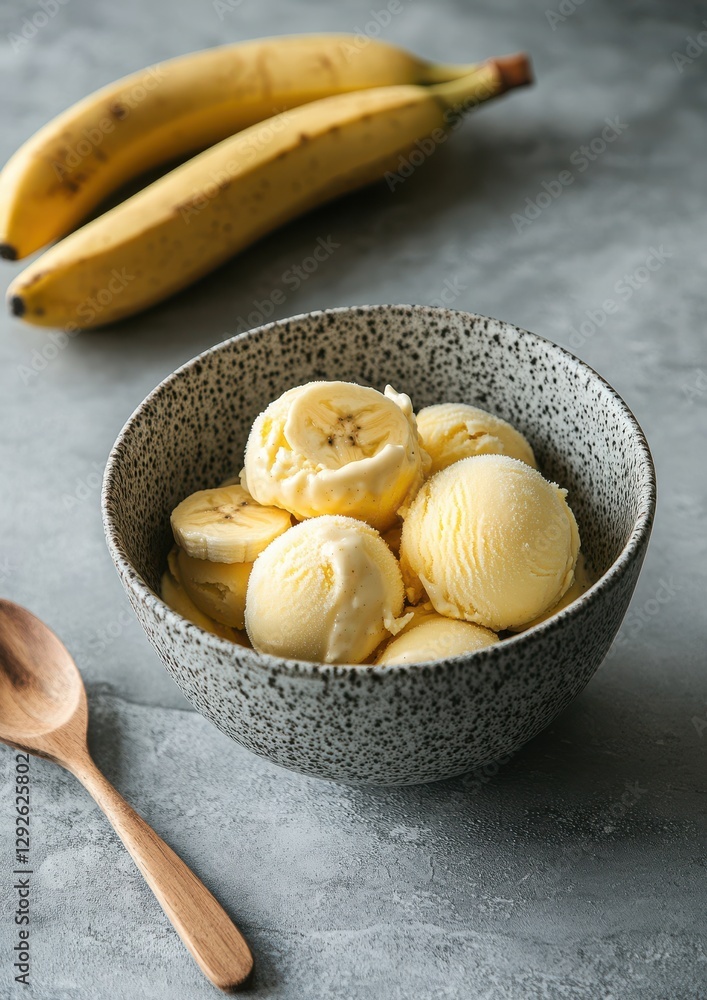 Poster fresh banana ice cream served in a stylish bowl with ripe bananas in the background creating a delig