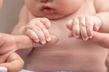 Tiny newborn baby human hands and fingers